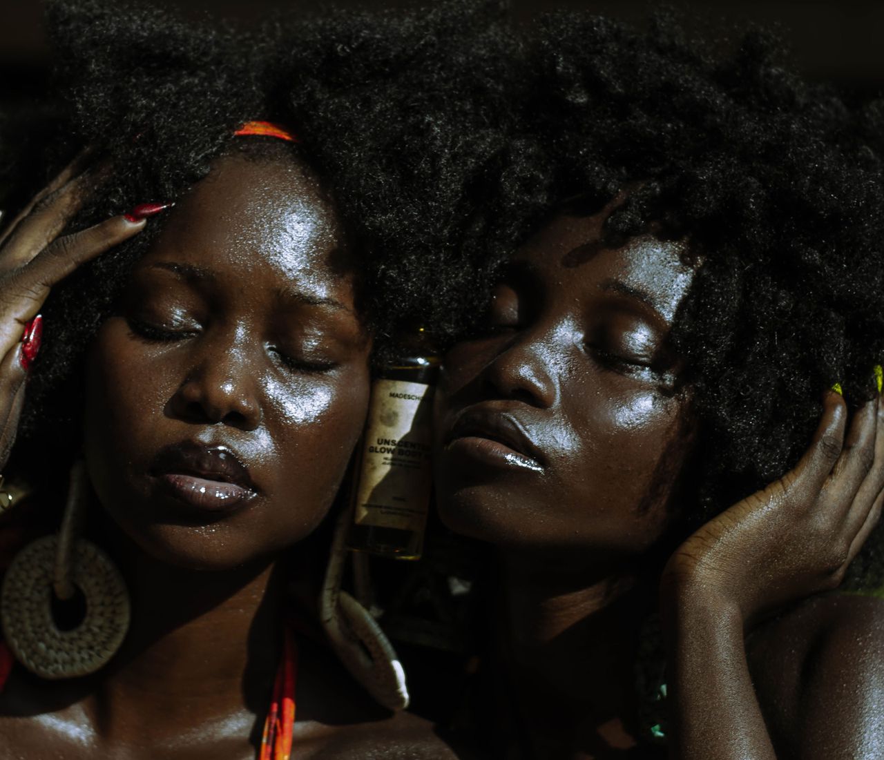 Menu Close-up portrait of two women with natural hairstyles enjoying sun in Lagos.